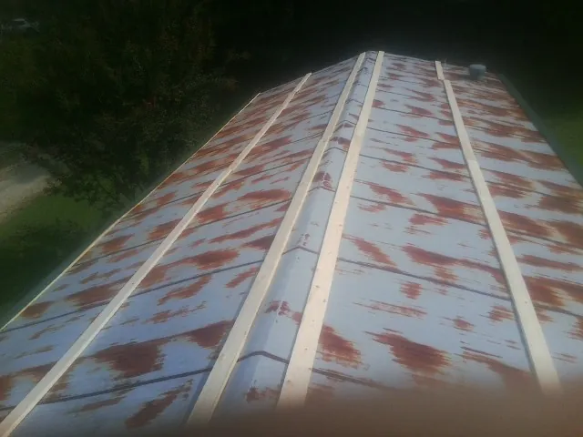 Rusted metal roof panels with new wood purlins before replacement — Storm Damage Roof Repair in Mabank by Roofing Brothers